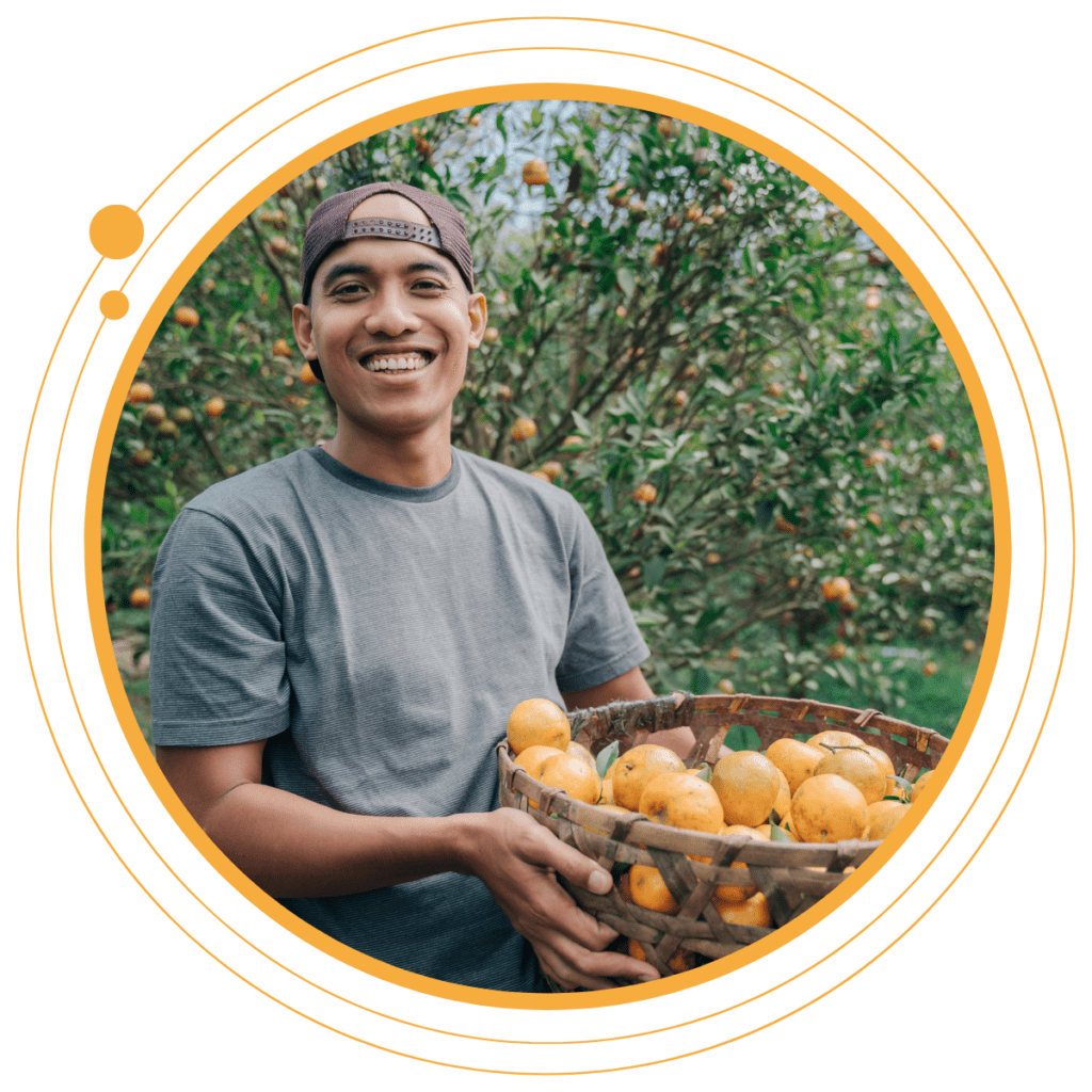 farmer holding a bsket of oranges