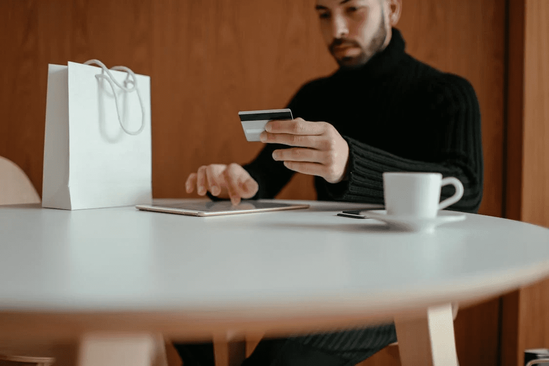  male doing online shopping with tablet and credit card