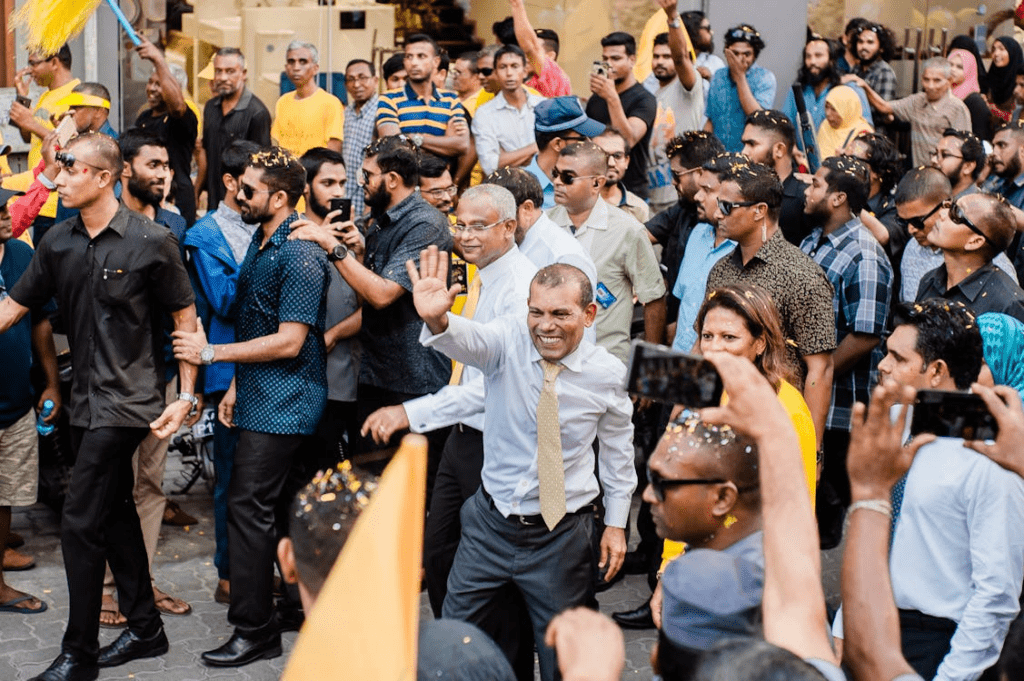 politician waiving at people