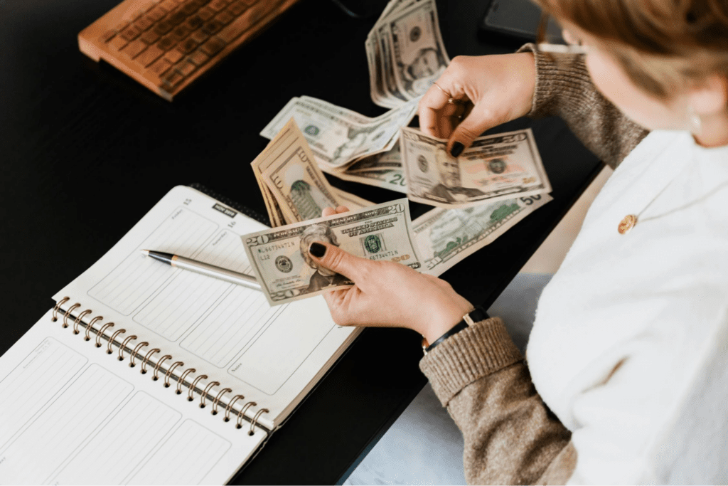 Close-up photo of a Person Counting Her Money