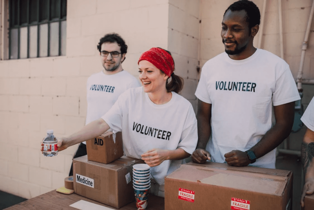 three people donating goods