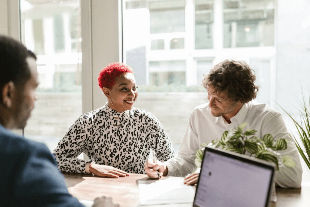 man in black and white long sleeve shirt sitting beside woman in white long 