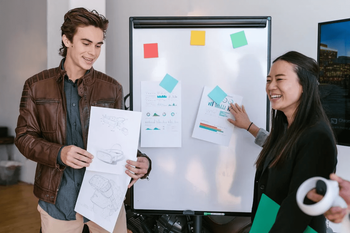 woman in black jacket holding white printer paper