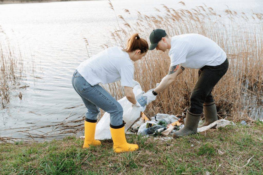  a man and a woman picking up garbage