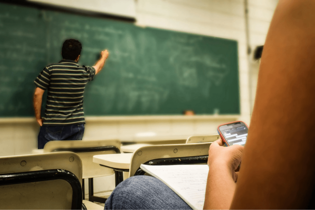 man in black and white polo shirt beside writing board